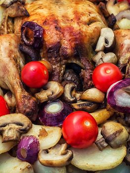 chicken baked with mushrooms,potatoes and vegetables in glass form.Photo tinted