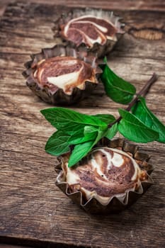 baked chocolate dessert in the iron forms on wooden surface.Photo tinted