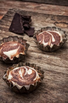 baked chocolate dessert in the iron forms on wooden surface