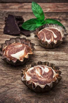 baked chocolate dessert in the iron forms on wooden surface