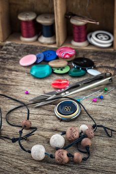 different tools for needlework beading and sewing in vintage style.Selective focus.Photo tinted