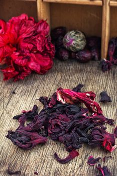 Hibiscus tea rose and welding on the background of the tea shelves in vintage style.Photo tinted