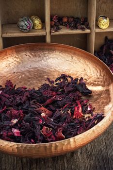 copper bowl with harvest dried leaves tea rose varieties hibiscus.Photo tinted