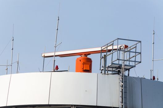 Tower at an international airport with radar on the roof.