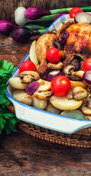 chicken baked with mushrooms,potatoes and vegetables in glass form.Photo tinted