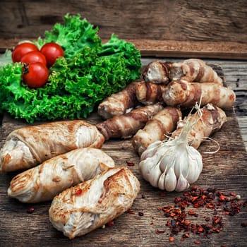 set fried meat sausages with salad on wooden background.Photo tinted