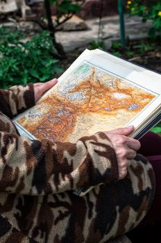 people considering and planning the travel route according to an old map.Selective focus