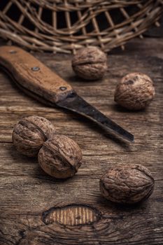 few walnuts on wooden background from autumn harvest.