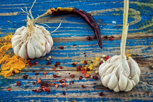 garlic,pepper and seasoning on wooden vintage background.Selective focus