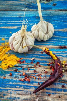 garlic,pepper and seasoning on wooden vintage background.Selective focus