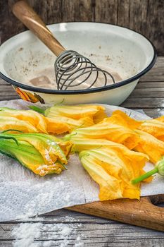 Cooking unusual dishes from pumpkin flowers in batter.Selective focus