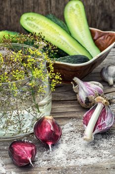 Cucumber pickled with dill and garlic on wooden table.Selective focus