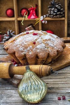 Sweet cupcake baked for the new year holiday on wooden table on  background of Christmas decorations.Photo tinted.Selective focus
