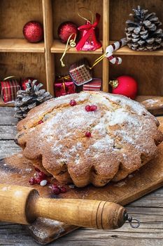 Sweet cupcake baked for the new year holiday on wooden table on  background of Christmas decorations.Photo tinted.Selective focus