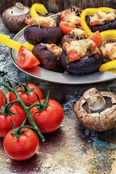 Easy appetizer of mushrooms stuffed with cheese,garlic and tomatoes.Photo tinted.