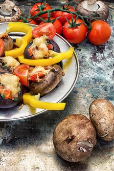 Easy appetizer of mushrooms stuffed with cheese,garlic and tomatoes.Photo tinted.