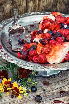 curd jelly cake with strawberries,raspberries and black currants on stand bunk