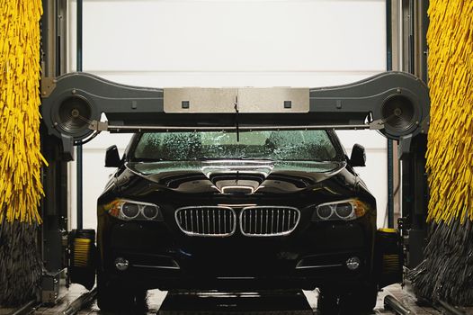 Black car drying in station washing tunnel