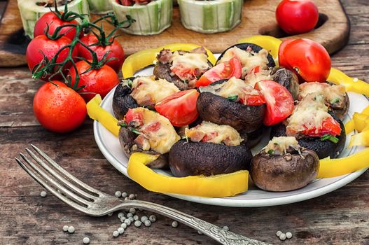 Easy appetizer of mushrooms stuffed with cheese,garlic and tomatoes.Photo tinted.