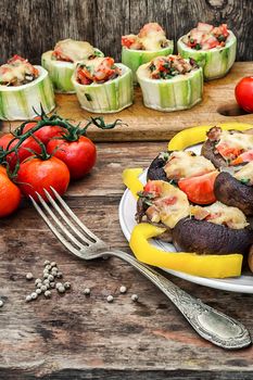 Easy appetizer of mushrooms stuffed with cheese,garlic and tomatoes.Photo tinted.Selective focus