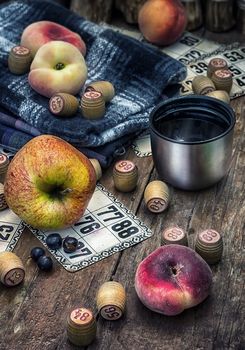 Accessories picnic consisting of peaches,apples and lotto games.Photo tinted.