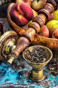 Details were worked hookah on the table amid fresh peaches.Photo tinted.