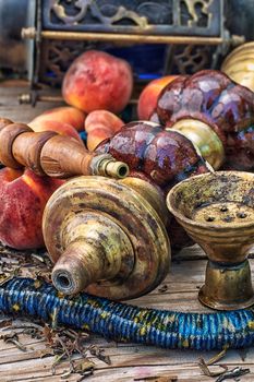 Details were worked hookah on the table amid fresh peaches.Photo tinted.Selective focus