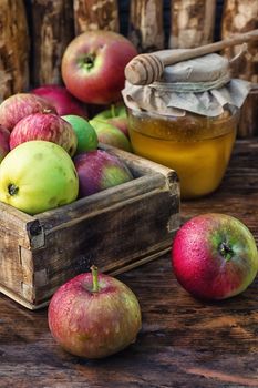 wooden box with the harvest of apples and honey for the holiday apple spas.Photo tinted.