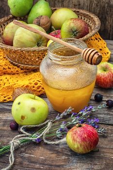 Still life from the harvest of ripe apples and honey to the Church celebration of the apple feast day.Photo tinted.