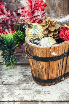wooden tub with pine cones and Christmas decorations and ornaments.