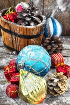 wooden tub with pine cones and Christmas decorations and ornaments.