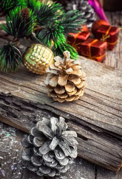 Christmas decorations with toys and cones on wooden plane.Photo tinted.