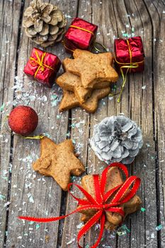 Christmas decorations and gingerbread cookies on wooden table .Photo tinted.