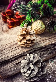 Christmas decorations with toys and cones on wooden plane.Photo tinted.