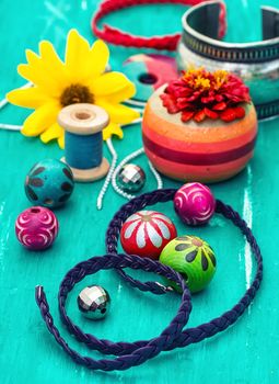 Wooden beads and accessories for needlework on old wooden  background