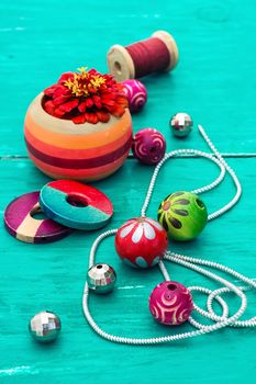 Wooden beads and accessories for needlework on old wooden  background