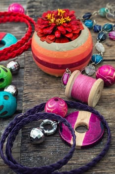 Wooden beads and accessories for needlework on old wooden  background