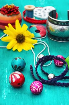 Wooden beads and accessories for needlework on old wooden  background