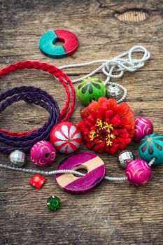 Wooden beads and accessories for needlework on old wooden  background