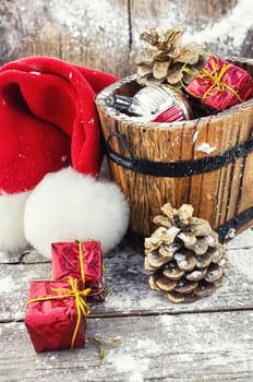 wooden tub with pine cones and Christmas decorations and ornaments.