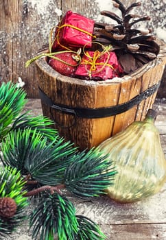 wooden tub with pine cones and Christmas decorations and ornaments.Selective focus