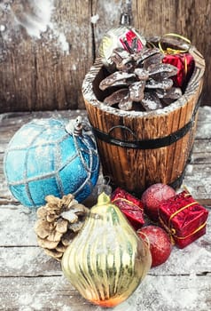 wooden tub with pine cones and Christmas decorations and ornaments.
