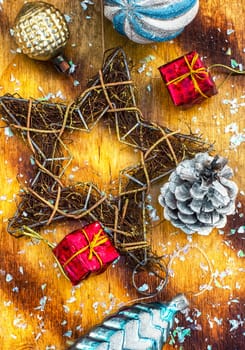 Festive Christmas decorations on wooden background in vintage style.Photo tinted.