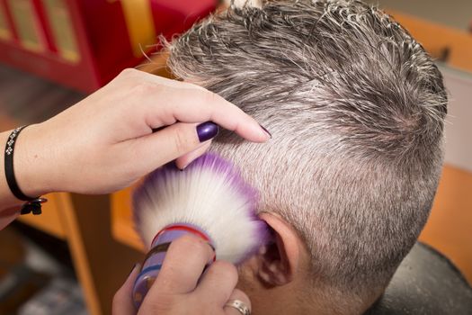 woman cuts hair with scissors, razor in  professional hairdressing salon