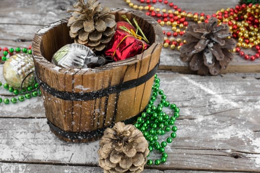 wooden tub with pine cones and Christmas decorations and ornaments.