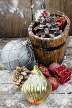 wooden tub with pine cones and Christmas decorations and ornaments.