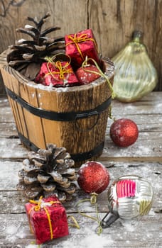 wooden tub with pine cones and Christmas decorations and ornaments.