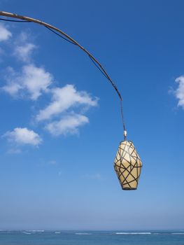 designed lantern by the sea with blue sky