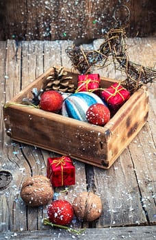 Wooden box filled with old fashion Christmas decorations.Photo tinted.