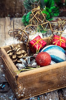 Wooden box filled with old fashion Christmas decorations.Photo tinted.